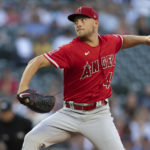 
              Los Angeles Angels starter Reid Detmers delivers a pitch during the first inning of the second game of a baseball doubleheader against the Seattle Mariners, Saturday, Aug. 6, 2022, in Seattle. (AP Photo/Stephen Brashear)
            