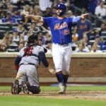 
              New York Mets' Pete Alonso (20) gestures after getting initially called out at home plate as Atlanta Braves catcher Travis d'Arnaud (16) watches during the sixth inning of the second game of a baseball doubleheader on Saturday, Aug. 6, 2022, in New York. Alonso was ruled safe after a challenge. (AP Photo/Jessie Alcheh)
            