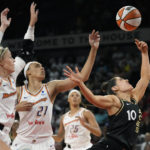 
              Phoenix Mercury guard Sophie Cunningham, left, fouls Las Vegas Aces guard Kelsey Plum (10) during the first half in Game 1 of a WNBA basketball first-round playoff series Wednesday, Aug. 17, 2022, in Las Vegas. (AP Photo/John Locher)
            