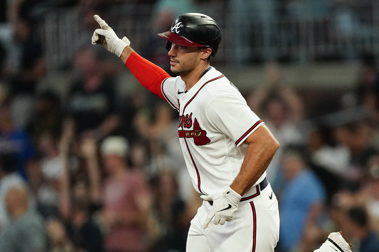 Atlanta Braves' Matt Olson gestures as he runs the bases after hitting a two-run home run during th...