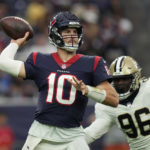 
              Houston Texans quarterback Davis Mills (10) is pressures by New Orleans Saints defensive end Carl Granderson (96) as the passes during the first half of an NFL preseason football game Saturday, Aug. 13, 2022, in Houston. (AP Photo/Eric Christian Smith)
            