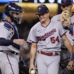 
              Minnesota Twins starting pitcher Sonny Gray, second from left, stands on the mound with catcher Gary Sanchez, left, Carlos Correa, second from right, and Luis Arraez before being taken out of the game during the fifth inning of a baseball game against the Los Angeles Dodgers Wednesday, Aug. 10, 2022, in Los Angeles. (AP Photo/Mark J. Terrill)
            