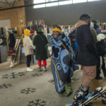 
              Visitors to the Afriski ski resort near Butha-Buthe, Lesotho, one wearing a traditional Basutu blanket, wait to rent ski gear Saturday July 30, 2022. While millions across Europe sweat through a summer of record-breaking heat, Afriski in the Maluti Mountains is Africa's only operating ski resort south of the equator. It draws people from neighboring South Africa and further afield by offering a unique experience to go skiing in southern Africa. (AP Photo/Jerome Delay)
            