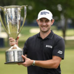 
              Patrick Cantlay holds the FedEx cup trophy after winning the the BMW Championship golf tournament at Wilmington Country Club, Sunday, Aug. 21, 2022, in Wilmington, Del. (AP Photo/Nick Wass)
            