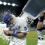 
              Kansas City Royals' Michael Massey, left, is doused by Bobby Witt Jr. after their baseball game against the Chicago White Sox Wednesday, Aug. 10, 2022, in Kansas City, Mo. The Royals won 8-3. (AP Photo/Charlie Riedel)
            