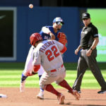
              Toronto Blue Jays second baseman Santiago Espinal throws to first base to complete a double play on Los Angeles Angels Mike Trout after forcing David Fletcher (22) at second during the third inning of a baseball game, Saturday, Aug. 27, 2022 in Toronto. (Jon Blacker/The Canadian Press via AP)
            