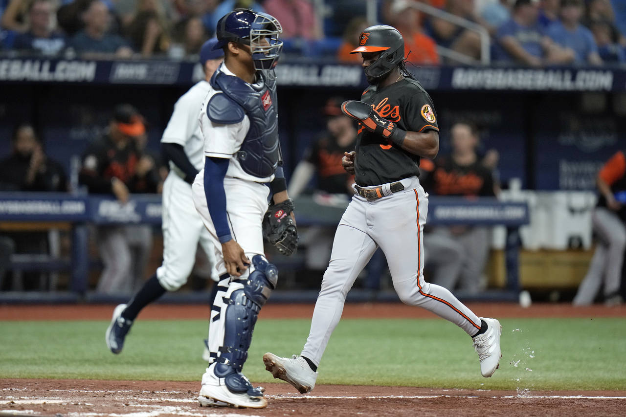 Baltimore Orioles' Jorge Mateo, right, scores in front of Tampa Bay Rays catcher Christian Bethanco...