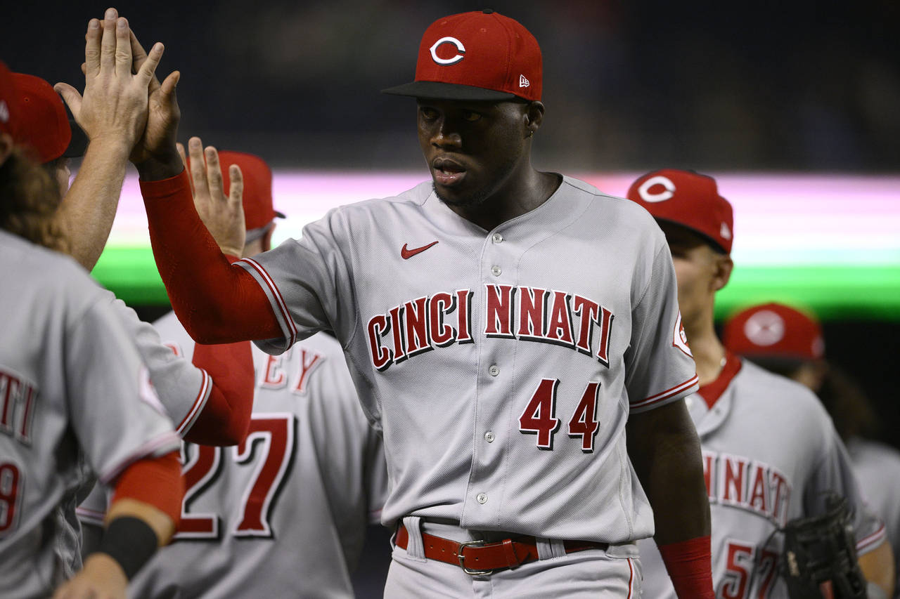 Cincinnati Reds' Aristides Aquino (44) and others celebrate after a baseball game against the Washi...