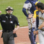 
              Home plate umpire Jerry Meals, left, ejects Christian Yelich, right, as manager Craig Counsell, steps in during the seventh inning of a baseball game against the Pittsburgh Pirates, Thursday, Aug. 4, 2022, in Pittsburgh. (AP Photo/Keith Srakocic)
            