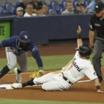 
              Tampa Bay Rays third baseman Yandy Diaz tags Miami Marlins' Luke Williams during the third inning of a baseball game, Tuesday, Aug. 30, 2022, in Miami. (AP Photo/Marta Lavandier)
            