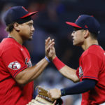 
              Cleveland Guardians' Josh Naylor, left, and Steven Kwan celebrate the team's 5-1 win against the Baltimore Orioles in a baseball game Tuesday, Aug. 30, 2022, in Cleveland. (AP Photo/Ron Schwane)
            