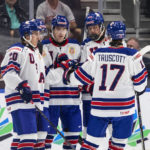
              United States' Red Savage (20), Riley Duran (8), Charlie Stramel (23) and Jacob Truscott (17) celebrate a goal against Austria during the first period of an IIHF World Junior Hockey Championship game in Edmonton, Alberta, Saturday, Aug. 13, 2022. (Jason Franson/The Canadian Press via AP)
            