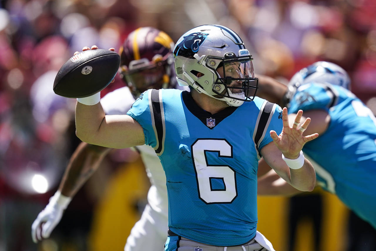 Carolina Panthers quarterback Baker Mayfield throws a pass during the first half of a NFL preseason...
