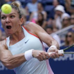 
              Simona Halep, of Romania, returns a shot to Daria Snigur, of Ukraine, during the first round of the US Open tennis championships, Monday, Aug. 29, 2022, in New York. (AP Photo/Seth Wenig)
            