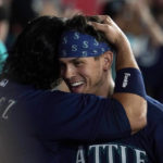 
              Seattle Mariners' Sam Haggerty, right, is hugged by Eugenio Suarez after Haggerty scored on a single by Ty France during the sixth inning of the team's baseball game against the Los Angeles Angels on Tuesday, Aug. 16, 2022, in Anaheim, Calif. (AP Photo/Marcio Jose Sanchez)
            