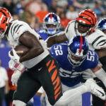 
              Cincinnati Bengals' Jacques Patrick, left, rushes past New York Giants' Carter Coughlin (52) to score a touchdown during the second half of a preseason NFL football game, Sunday, Aug. 21, 2022, in East Rutherford, N.J. (AP Photo/John Minchillo)
            