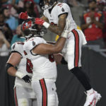 
              Tampa Bay Buccaneers wide receiver Jerreth Sterns (9) celebrates with offensive tackle Dylan Cook (65) after scoring against the Miami Dolphins during the second half of an NFL preseason football game Saturday, Aug. 13, 2022, in Tampa, Fla. (AP Photo/Phelan M. Ebenhack)
            