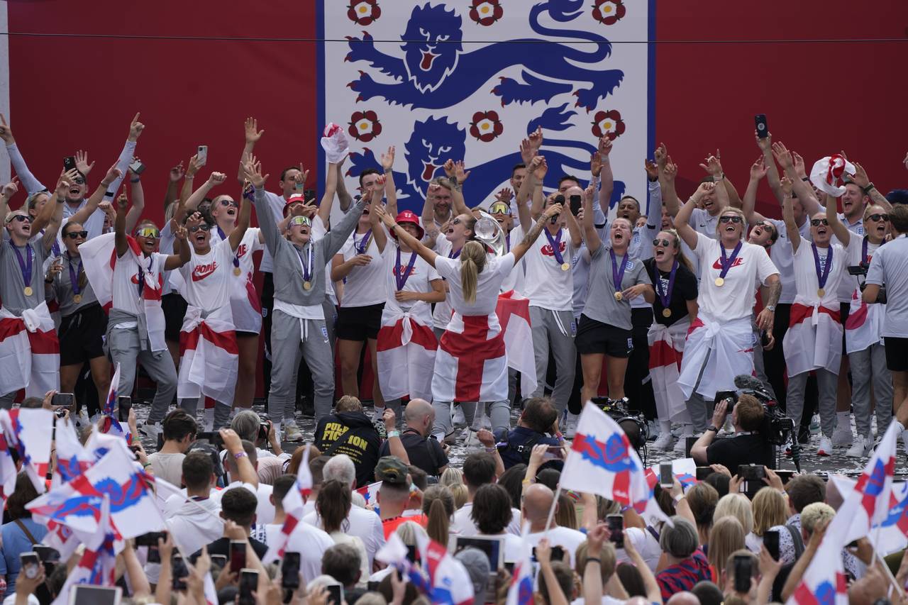 England players celebrate on stage at an event at Trafalgar Square in London, Monday, Aug. 1, 2022....