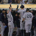 
              New York Yankees' Aaron Judge, middle, celebrates with teammates after hitting a three-run home run against the Oakland Athletics during the fifth inning of a baseball game in Oakland, Calif., Friday, Aug. 26, 2022. (AP Photo/Jeff Chiu)
            
