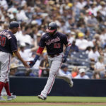 
              Washington Nationals' Nelson Cruz, right, reacts with third base coach Gary Disarcina after hitting a home run during the fourth inning of a baseball game against the San Diego Padres, Sunday, Aug. 21, 2022, in San Diego. (AP Photo/Gregory Bull)
            