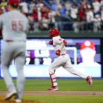 
              Philadelphia Phillies' Nick Castellanos, right, rounds the bases after hitting a home run against Cincinnati Reds pitcher Luis Cessa during the second inning of a baseball game, Monday, Aug. 22, 2022, in Philadelphia. (AP Photo/Matt Slocum)
            