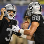
              Las Vegas Raiders quarterback Jarrett Stidham (3) celebrates with tight end Jacob Hollister (88) after Stidham scrambled for a touchdown during the first half of the team's NFL football exhibition Hall of Fame Game against the Jacksonville Jaguars, Thursday, Aug. 4, 2022, in Canton, Ohio. (AP Photo/David Richard)
            