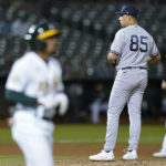 
              New York Yankees relief pitcher Greg Weissert (85) looks toward home plate after walking Oakland Athletics' Tony Kemp, foreground, to load the bases during the seventh inning of a baseball game in Oakland, Calif., Thursday, Aug. 25, 2022. (AP Photo/Godofredo A. Vásquez)
            