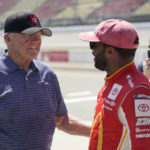 
              Joe Gibbs, left, congratulates Bubba Wallace, after winning the pole position, during NASCAR Cup Series auto race qualifying at the Michigan International Speedway in Brooklyn, Mich., Saturday, Aug. 6, 2022. (AP Photo/Paul Sancya)
            