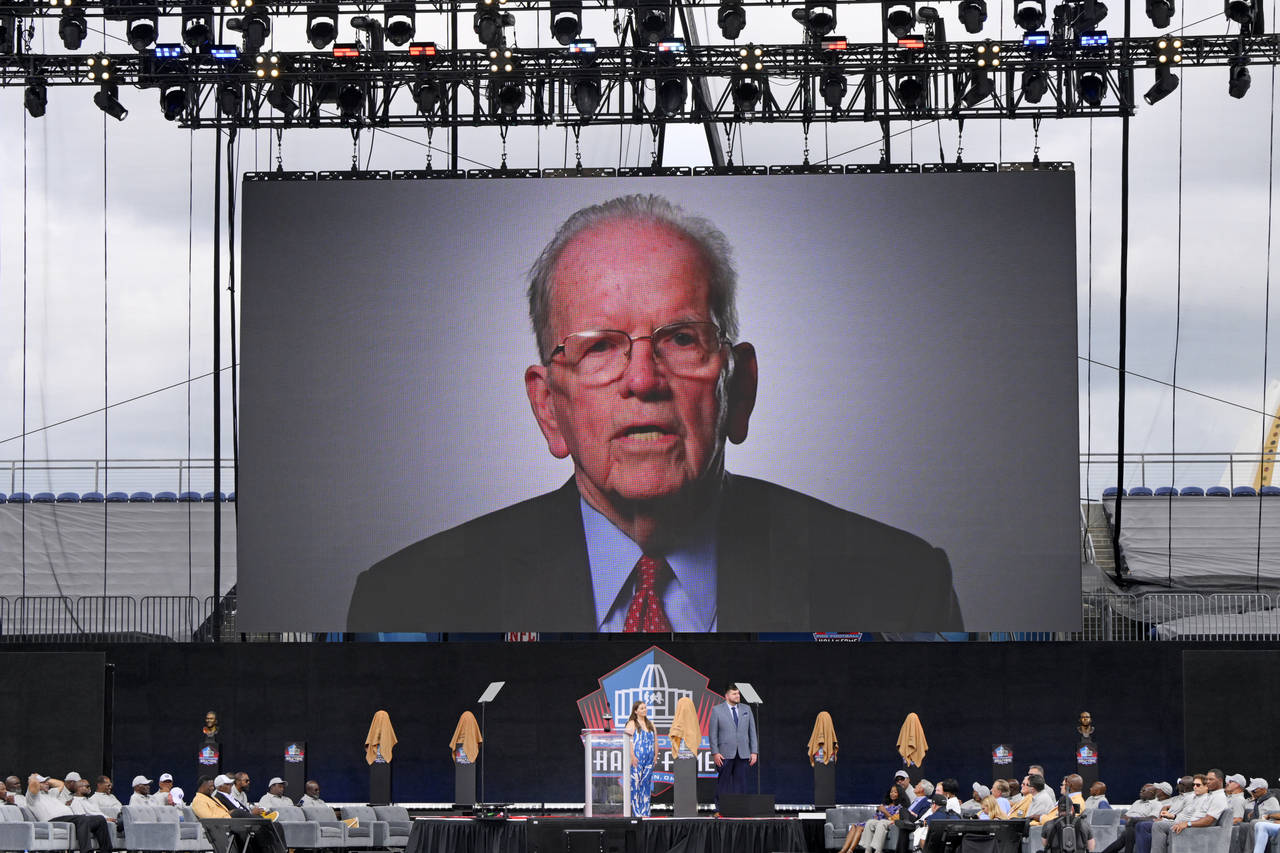 A video of NFL official Art McNally is played pose during an induction ceremony at the Pro Football...
