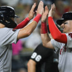 
              Boston Red Sox's Eric Hosmer, left, and Reese McGuire, celebrate after scoring against the Kansas City Royals on a double by Jarren Duran during the eighth inning of a baseball game Friday, Aug. 5, 2022, in Kansas City, Mo. (AP Photo/Reed Hoffmann)
            