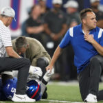 
              Trainers check on New York Giants defensive end Kayvon Thibodeaux after he was injured during the first half of a preseason NFL football game against the Cincinnati Bengals, Sunday, Aug. 21, 2022, in East Rutherford, N.J. (AP Photo/John Minchillo)
            