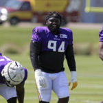 
              Minnesota Vikings defensive tackle Dalvin Tomlinson (94) jokes with teammates at the NFL football team's practice facility in Eagan, Minn., Friday, Aug. 5, 2022. (AP Photo/Stacy Bengs)
            