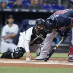 
              Atlanta Braves' Austin Riley reacts after he is hit by a pitch as Miami Marlins catcher Nick Fortes looks on during the first inning of a baseball game against the Miami Marlins, Sunday, Aug. 14, 2022, in Miami. (AP Photo/Wilfredo Lee)
            