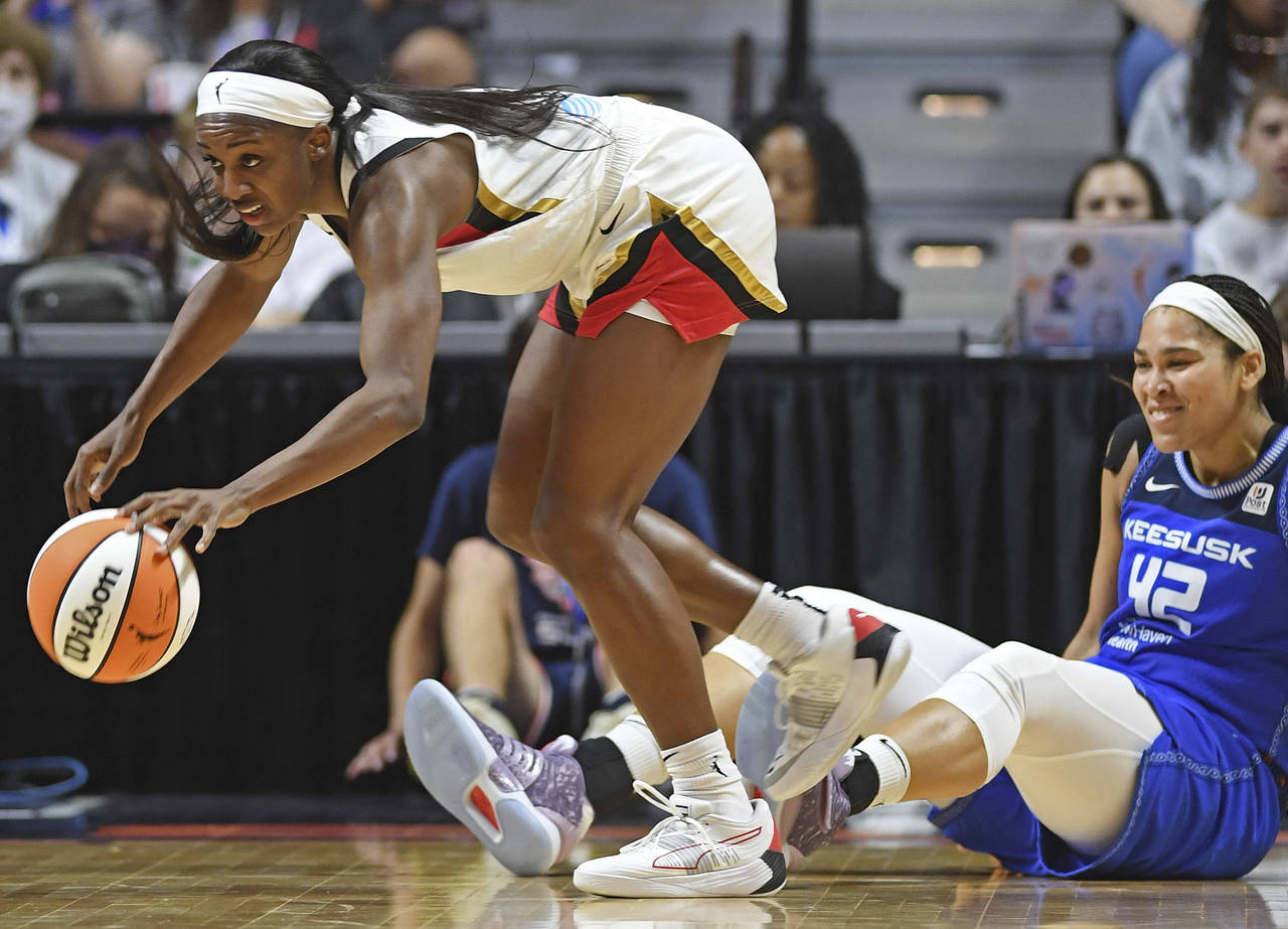Las Vegas Aces guard Jackie Young (0) takes the ball away from Connecticut Sun center Brionna Jones...