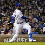 
              Chicago Cubs' Franmil Reyes watches his RBI single off Washington Nationals relief pitcher Kyle Finnegan during the seventh inning of a baseball game Tuesday, Aug. 9, 2022, in Chicago. (AP Photo/Charles Rex Arbogast)
            