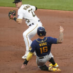 
              Milwaukee Brewers' Kolten Wong (16) is forced out sliding into second as Pittsburgh Pirates shortstop Kevin Newman (27) prepares to throw to first on a double play hit into by Hunter Renfroe during the second inning of a baseball game Tuesday, Aug. 2, 2022, in Pittsburgh. (AP Photo/Keith Srakocic)
            