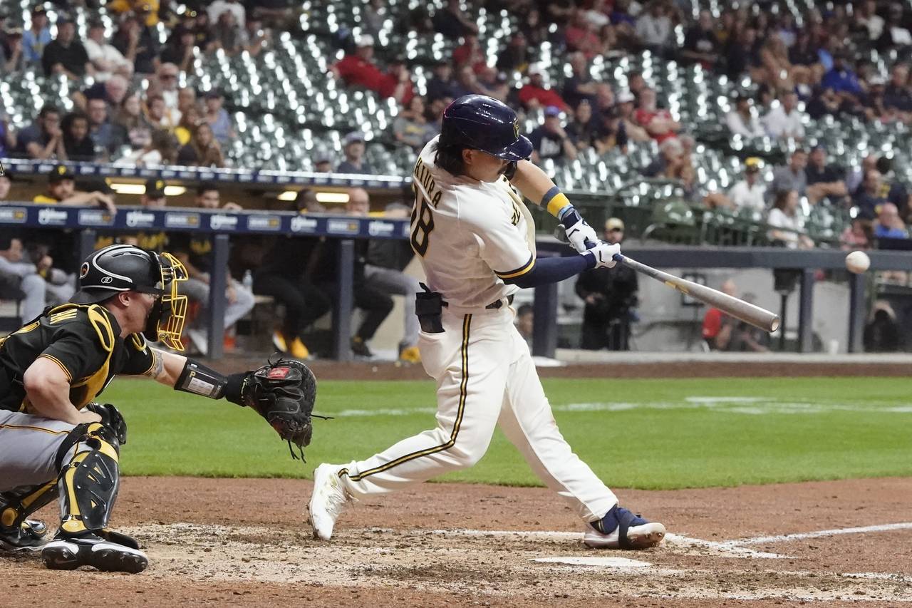 Milwaukee Brewers' Keston Hiura hits a walk off two-run home during the ninth inning of a baseball ...