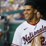 
              FILE - Washington Nationals' Juan Soto smiles in the dugout after a solo home run during a baseball game against the New York Mets at Nationals Park, Monday, Aug. 1, 2022, in Washington. the Nationals on Tuesday, Aug. 2, 2022, in one of baseball's biggest deals at the trade deadline, vaulting their postseason chances by adding a World Series champion who is one of baseball’s best hitters in his early 20s. A person with direct knowledge of the move told The Associated Press the Padres and Nationals have agreed to a multiplayer deal contingent on San Diego first baseman Eric Hosmer waiving his no-trade provision. The person spoke to the AP on condition of anonymity because negotiations were ongoing. (AP Photo/Alex Brandon, File)
            