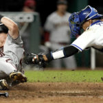 
              Arizona Diamondbacks' Jake McCarthy is tagged out by Kansas City Royals catcher Salvador Perez as he tried to score on a fielders choice hit into by Alek Thomas during the ninth inning of a baseball game Tuesday, Aug. 23, 2022, in Kansas City, Mo. The Diamondbacks won 7-3. (AP Photo/Charlie Riedel)
            