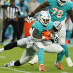 
              Las Vegas Raiders linebacker Darien Butler (58) tackles Miami Dolphins running back Chase Edmonds (2) during the first half of a NFL preseason football game, Saturday, Aug. 20, 2022, in Miami Gardens, Fla. (AP Photo/Lynne Sladky)
            