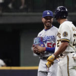 
              Milwaukee Brewers' Willy Adames (27) laughs with Los Angeles Dodgers' Mookie Betts (50) during the seventh inning of a baseball game Tuesday, Aug. 16, 2022, in Milwaukee. (AP Photo/Aaron Gash)
            