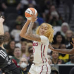 
              Washington Mystics center Shakira Austin, center, tries to pass around the defense of Seattle Storm guard Sue Bird, left, and center Tina Charles, right, during the first half of a WNBA basketball playoff game, Sunday, Aug. 21, 2022, in Seattle. (AP Photo/Ted S. Warren)
            