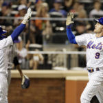 
              New York Mets' Brandon Nimmo (9) celebrates with Francisco Lindor (12) after scoring a run during the seventh inning of a baseball game on Saturday, Aug. 27, 2022, in New York. (AP Photo/Adam Hunger)
            