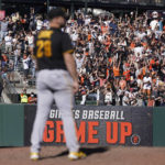 
              Fans cheer as Pittsburgh Pirates pitcher Wil Crowe, foreground, reacts after San Francisco Giants' Thairo Estrada hit a two-run home run during the ninth inning of a baseball game in San Francisco, Sunday, Aug. 14, 2022. (AP Photo/Jeff Chiu)
            