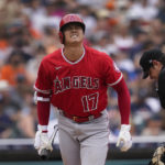 
              Los Angeles Angels' Shohei Ohtani reacts to fouling a ball off his foot against the Detroit Tigers in the seventh inning of a baseball game in Detroit, Saturday, Aug. 20, 2022. (AP Photo/Paul Sancya)
            