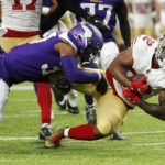 
              San Francisco 49ers running back Tyrion Davis-Price (32) is tackled by Minnesota Vikings safety Mike Brown, left, during the second half of a preseason NFL football game, Saturday, Aug. 20, 2022, in Minneapolis. (AP Photo/Bruce Kluckhohn)
            