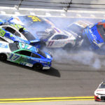 
              Chris Buescher (17), Daniel Suarez (99), Denny Hamlin (11), Justin Haley (31), Ty Dillon (42), Aric Almirola (10) and Ricky Stenhouse Jr. (47) are involved in a multi-car accident between turns 1 and 2 during a NASCAR Cup Series auto race at Daytona International Speedway, Sunday, Aug. 28, 2022, in Daytona Beach, Fla. (AP Photo/Dow Graham)
            