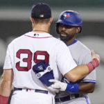 
              Toronto Blue Jays' Jackie Bradley Jr., right, is embraced by Boston Red Sox second baseman Christian Arroyo (39), his former teammate with the Red Sox, during the third inning of a baseball game, Tuesday, Aug. 23, 2022, in Boston. (AP Photo/Charles Krupa)
            