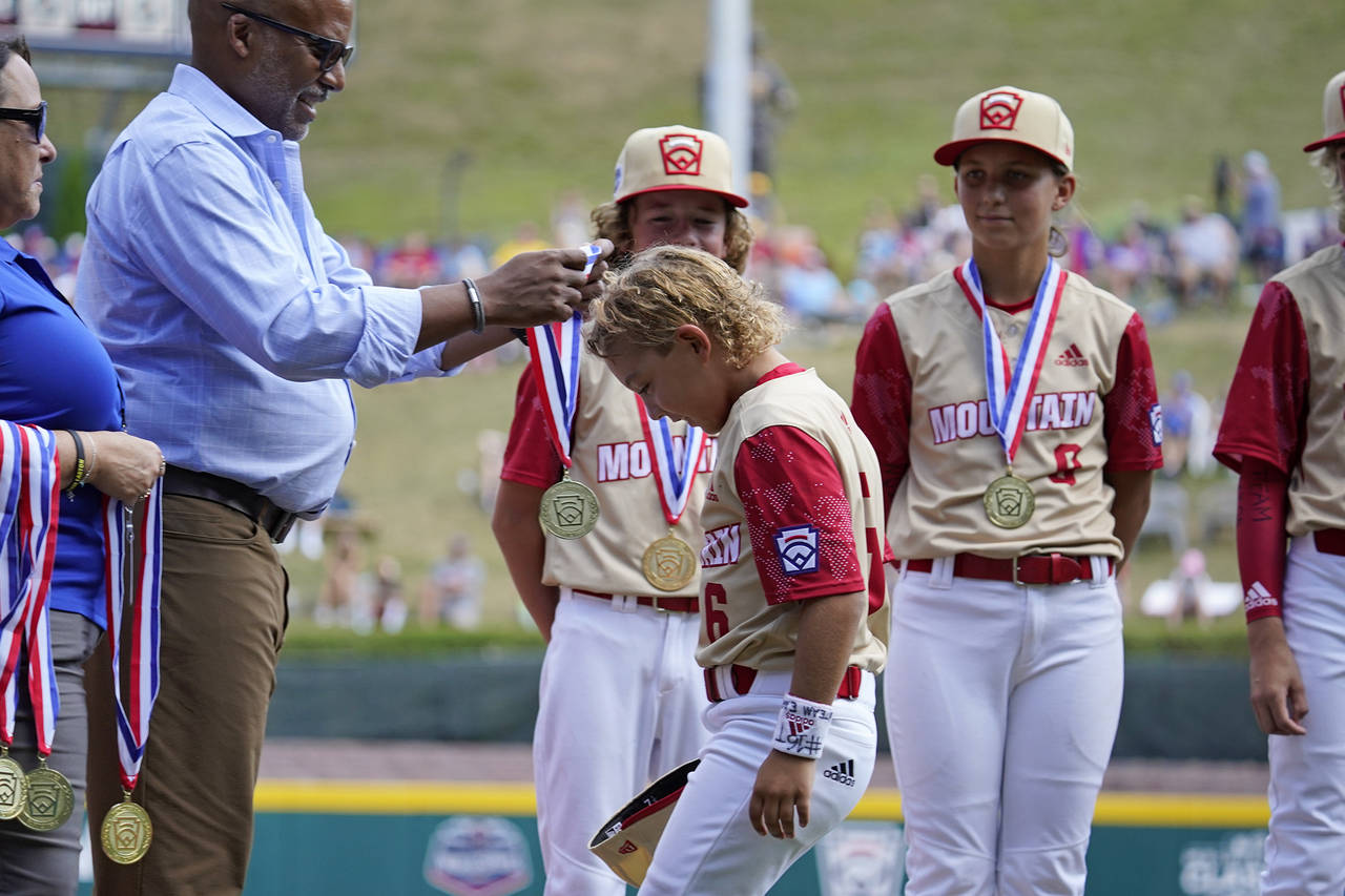 Santa Clara, Utah's Brogan Oliverson, center, receives a medal during player introductions before a...