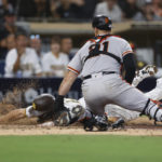 
              San Diego Padres' Brandon Drury, left, is tagged out at the plate by San Francisco Giants catcher Joey Bart during the eighth inning of a baseball game, Monday, Aug. 8, 2022, in San Diego. (AP Photo/Mike McGinnis)
            